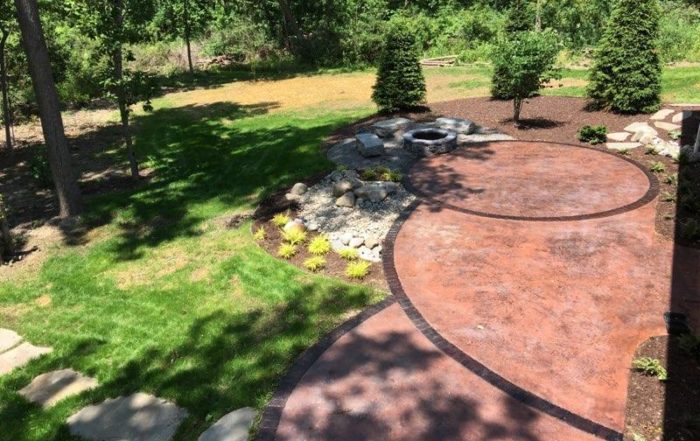Stamped concrete patio vs paver patio in Mid Michigan landscaping project