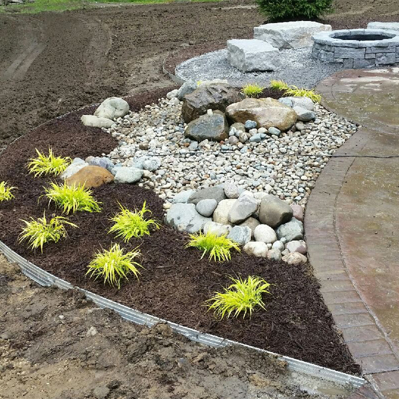a garden with rocks and plants in it.