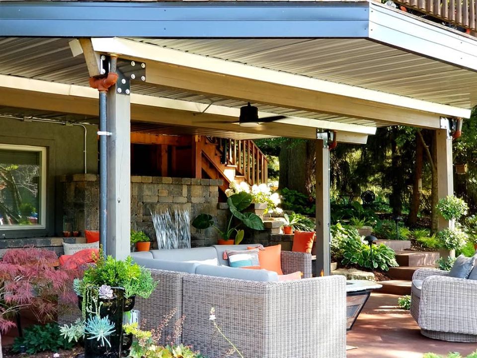 a patio covered with furniture and plants.